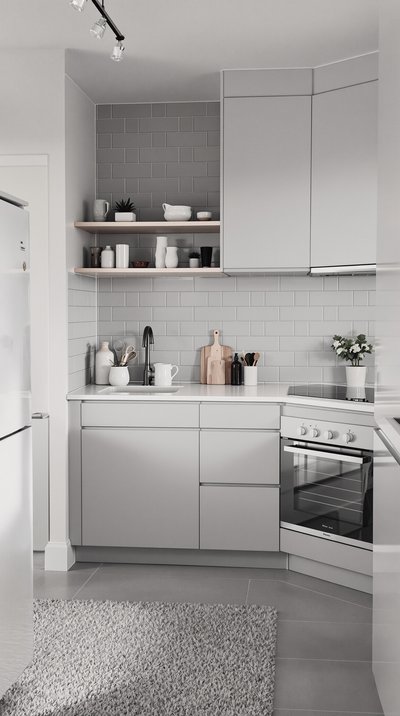 Minimalistische skandinavische Küche mit hellgrauen Fliesen und weißen Geräten.